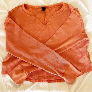 This is a wild fable, long sleeve, orange shirt in a size XS.